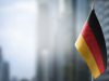 a-small-flag-of-germany-on-the-background-of-a-blurred-background